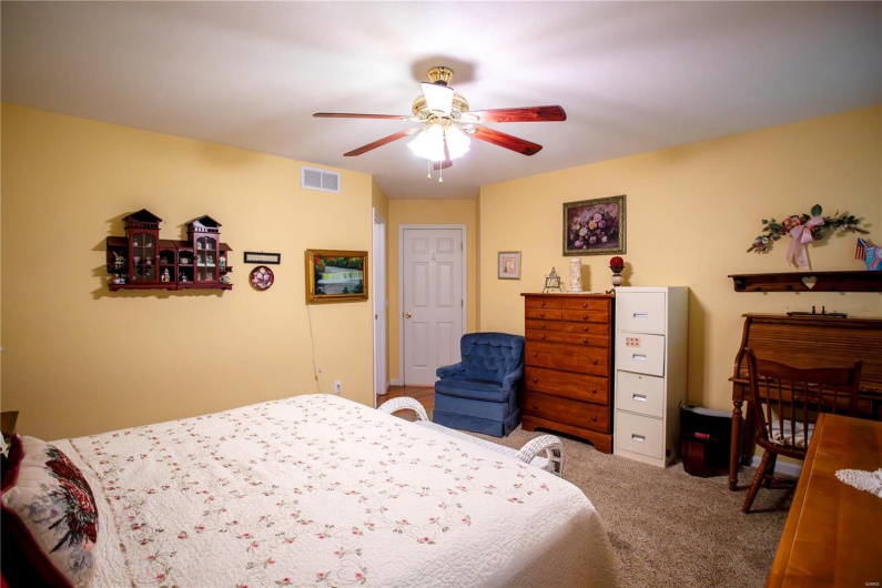 Bedroom with ceiling fan, carpet flooring, and visible vents