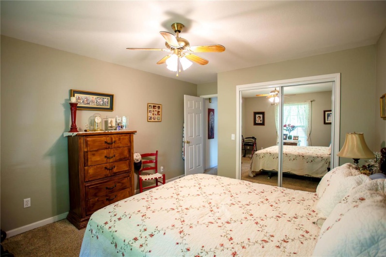 Bedroom featuring carpet, a closet, baseboards, and a ceiling fan