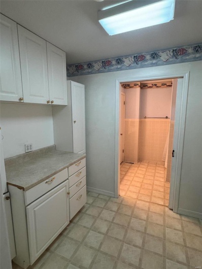 Kitchen featuring white cabinets