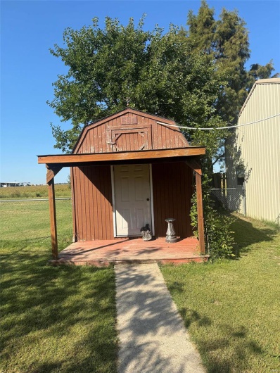 View of outbuilding with a lawn