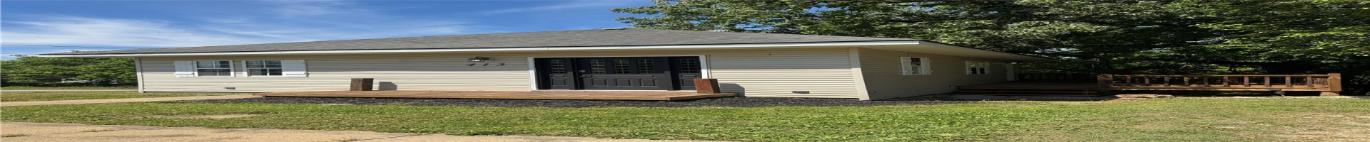 Residential For Sale View of front of home with a front yard, a wooden deck, and roof with shingles