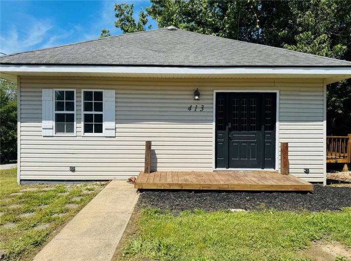 View of front of home featuring a shingled roof