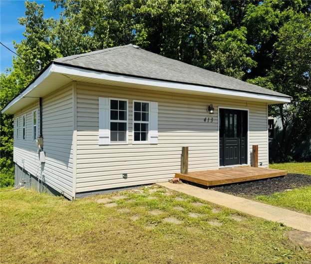 Bungalow-style house featuring a front lawn and roof with shingles