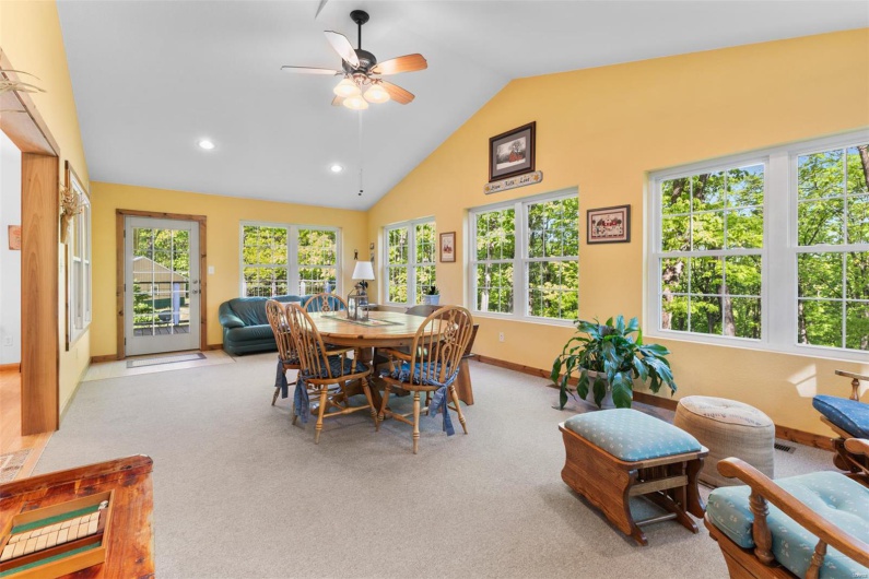 Dining space with baseboards, carpet flooring, a healthy amount of sunlight, and ceiling fan