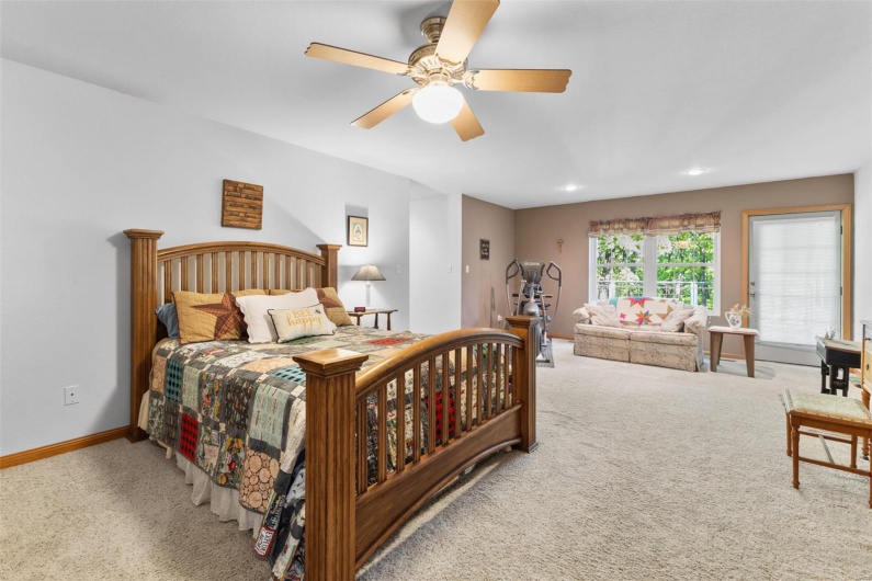 Carpeted bedroom with baseboards, recessed lighting, and a ceiling fan