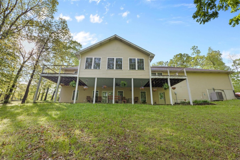 Rear view of house with a lawn, central air condition unit, a deck, and a ceiling fan