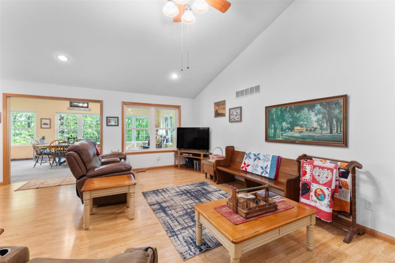 Living room with visible vents, wood finished floors, and baseboards