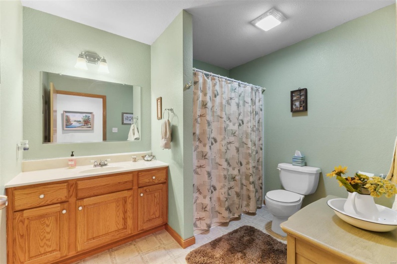Bathroom featuring vanity, toilet, and a shower with shower curtain