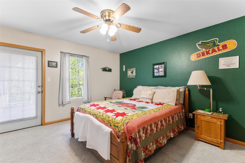 Bedroom with ceiling fan, light carpet, and baseboards