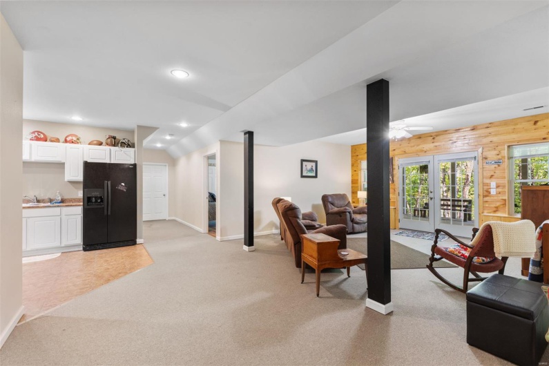Living room featuring french doors, recessed lighting, baseboards, ceiling fan, and light carpet