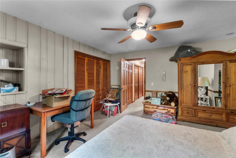 Office with a ceiling fan, carpet flooring, and a textured ceiling