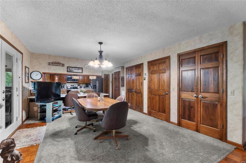 Dining area featuring a textured ceiling, a chandelier, and baseboards