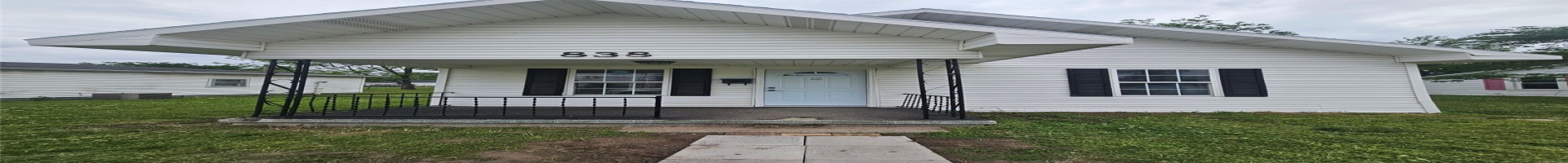 Residential For Sale View of front of property with covered porch, a front lawn, and central AC unit