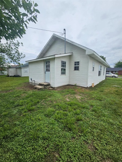 Rear view of house featuring a yard