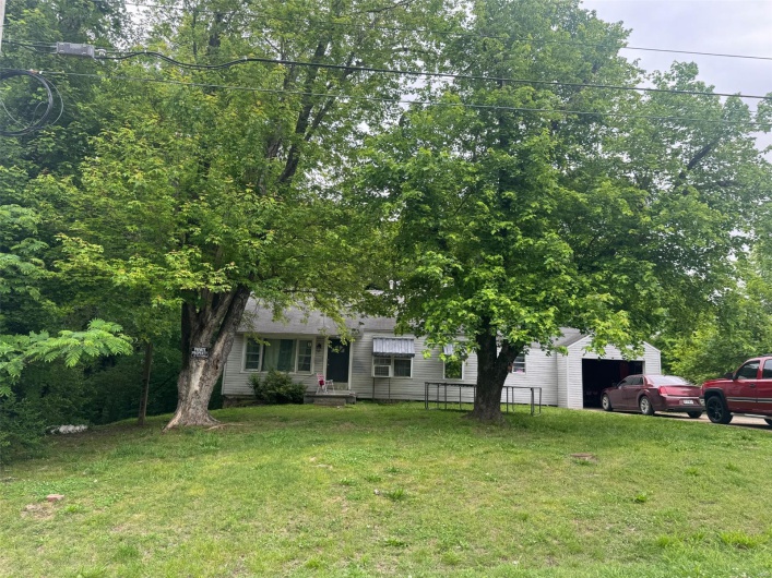Obstructed view of property featuring a front lawn