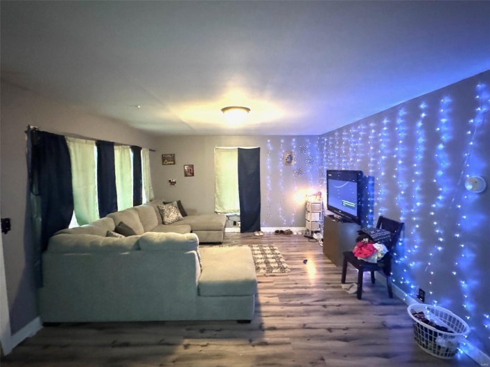 Living room with wood finished floors and baseboards