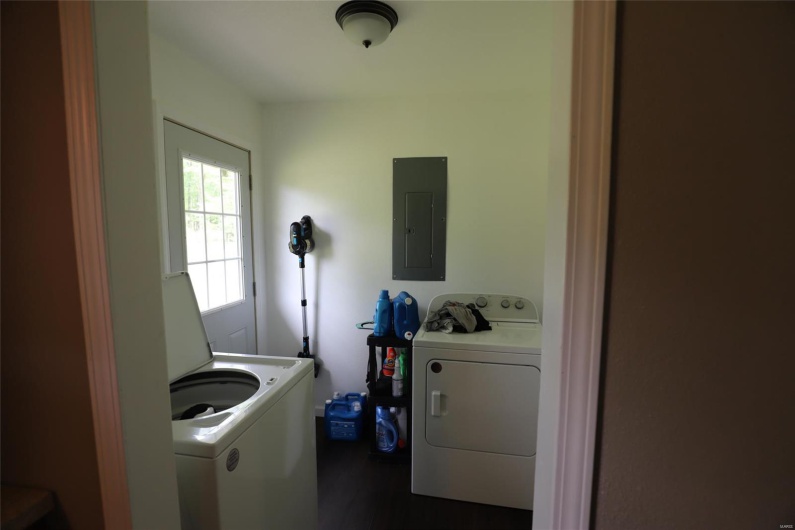 Laundry / Mud room with access to the Back yard and on the right the Master Bedroom 
