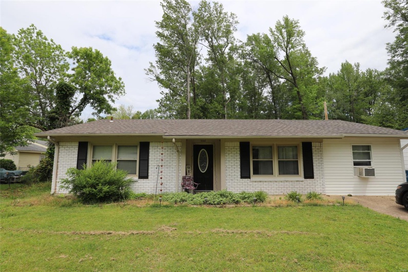 Front of the Home from the street has a window unit in the converted Master 