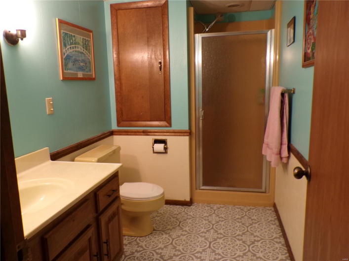 Large full Bath featuring a shower stall, vanity, and toilet.