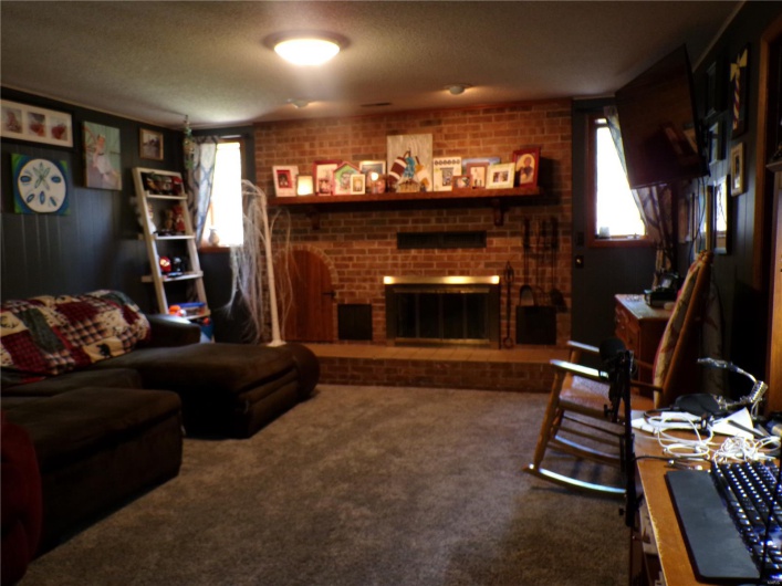Carpeted Family Room  featuring plenty of natural light, and textured ceiling.