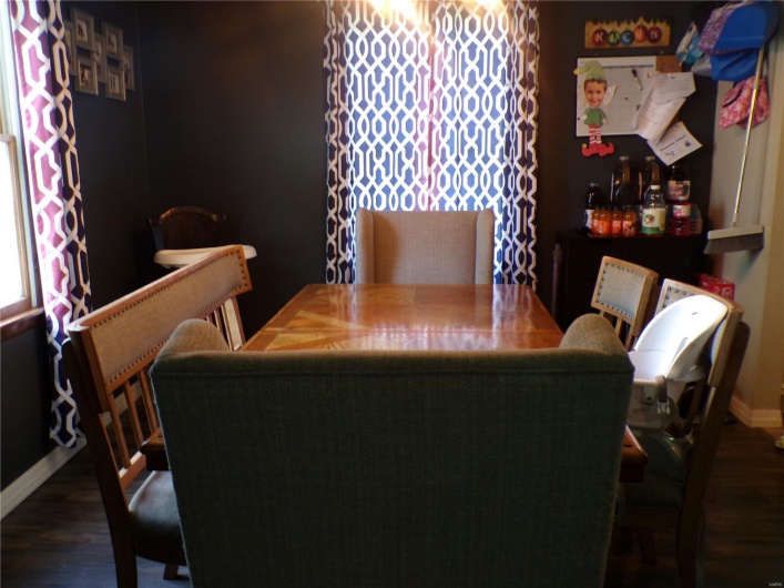 Large open dining room featuring vinyl flooring and natural lighting.