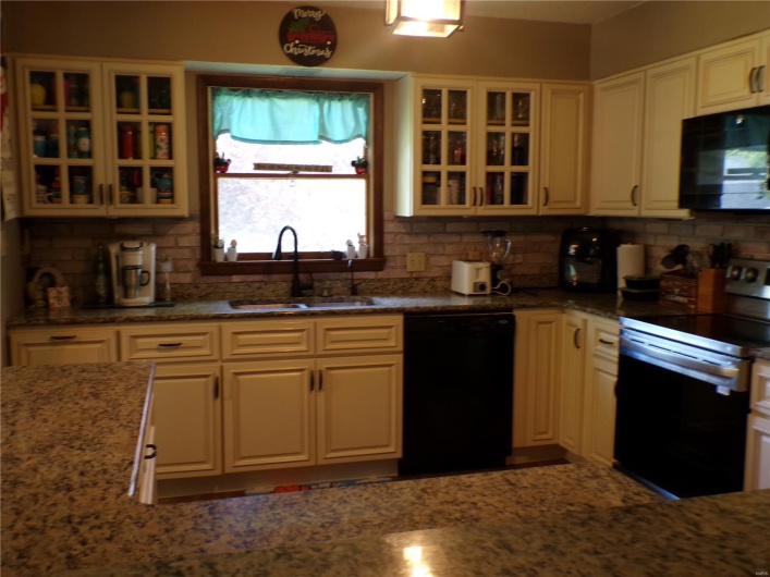 Kitchen with ample solid surface counters and  appliances.