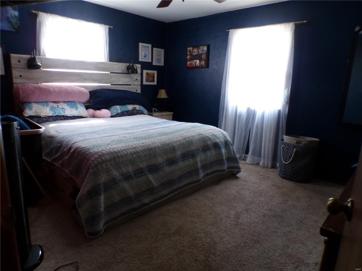 Carpeted Primary Bedroom featuring a ceiling fan