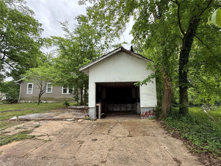View of front of property with driveway, stucco siding, and an attached garage