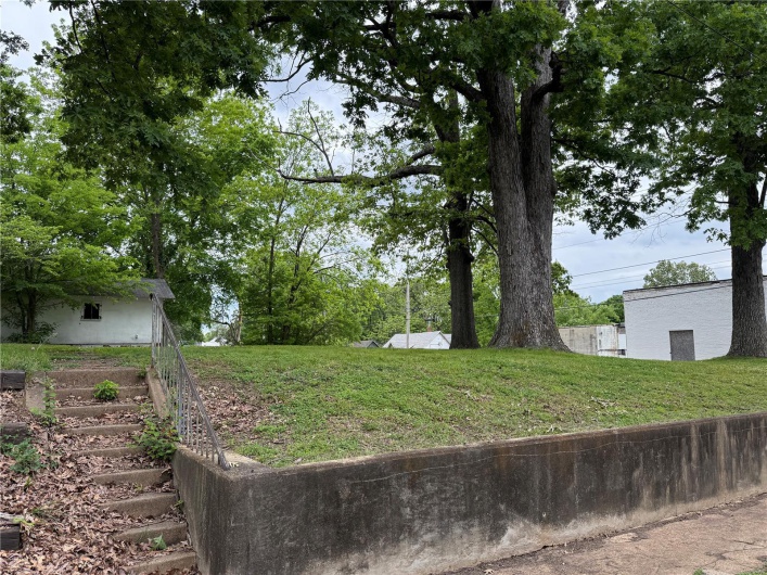View of green lawn featuring stairway