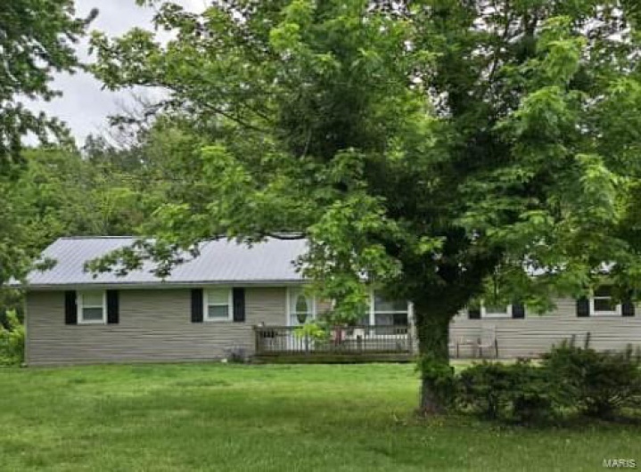 Back of property with a yard
