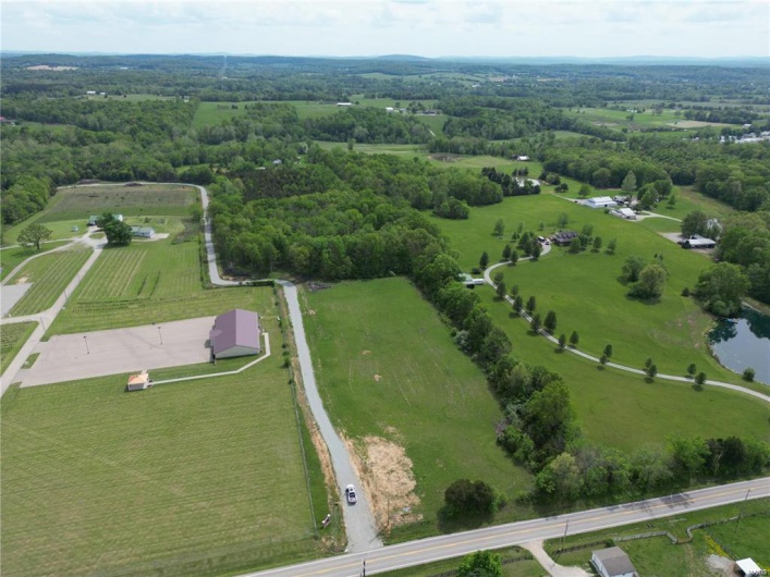 Aerial view of property and surrounding area with rural landscape