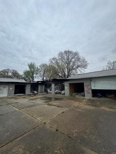 View of front of house with metal roof and a garage