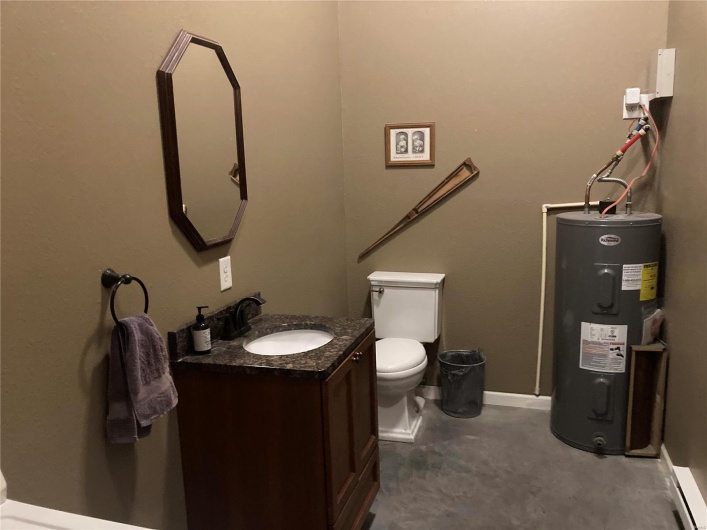 Bathroom with vanity, toilet, and electric water heater