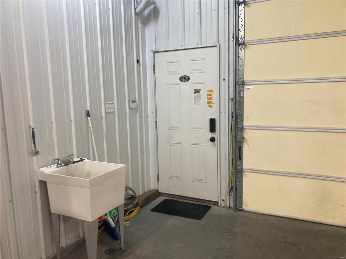 View of garage walk through entry featuring sink