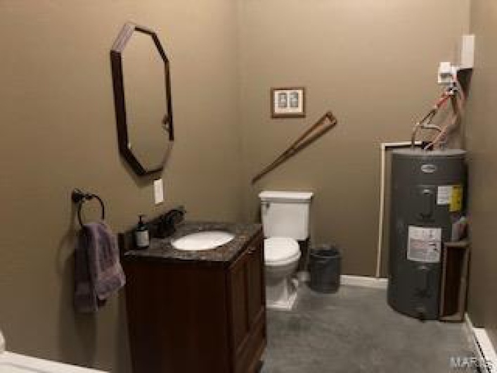 Bathroom with vanity, toilet, and water heater