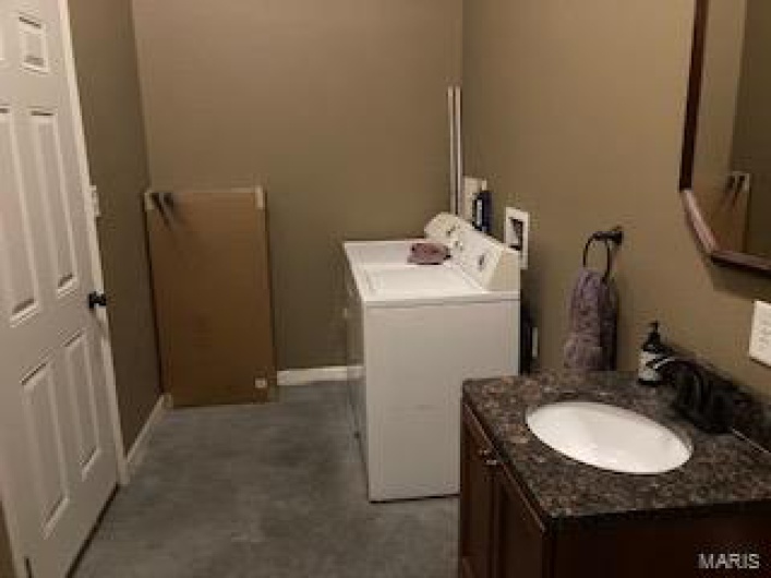 Bathroom with vanity and washer / clothes dryer