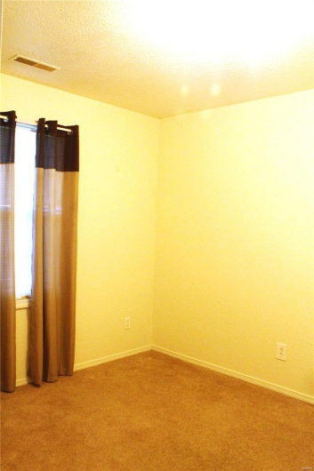 Unfurnished room with light colored carpet and baseboards