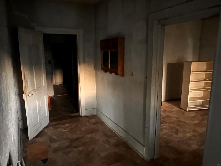 Corridor featuring unfinished concrete floors