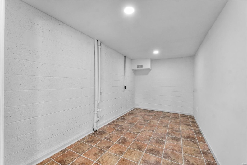 Finished basement featuring recessed lighting