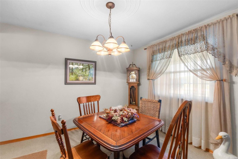 Dining area with a chandelier and carpet