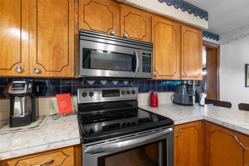 Kitchen with hardwood / wood-style floors, tasteful backsplash, and stainless steel appliances