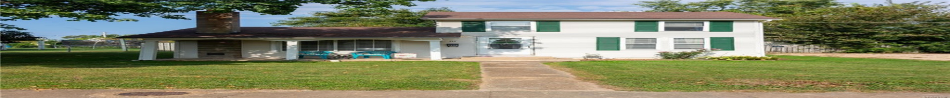 Residential For Sale View of front of property featuring a trampoline, a front lawn, and a chimney