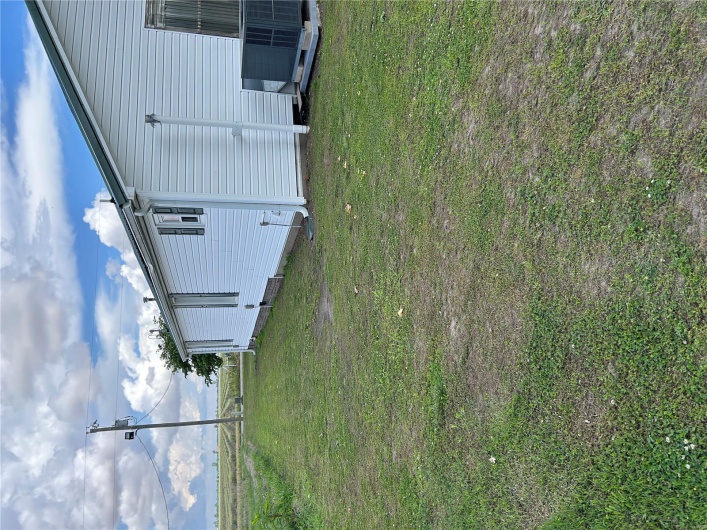View of green lawn with cooling unit