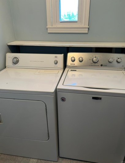 Washroom featuring washing machine and dryer