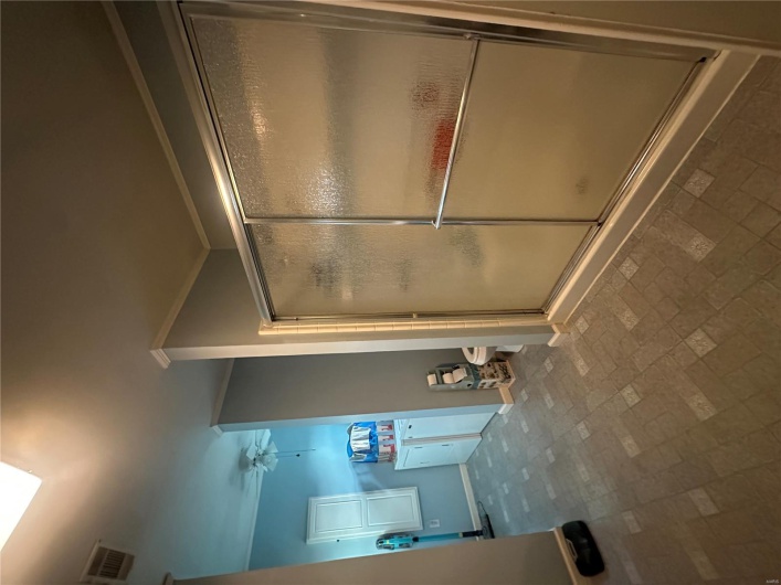 Full bathroom with baseboards, a shower stall, toilet, crown molding, and ceiling fan