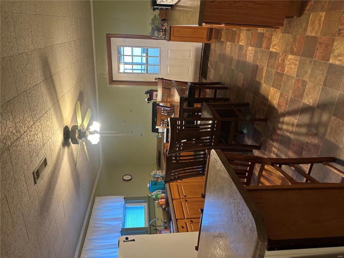 Dining space featuring a ceiling fan and crown molding