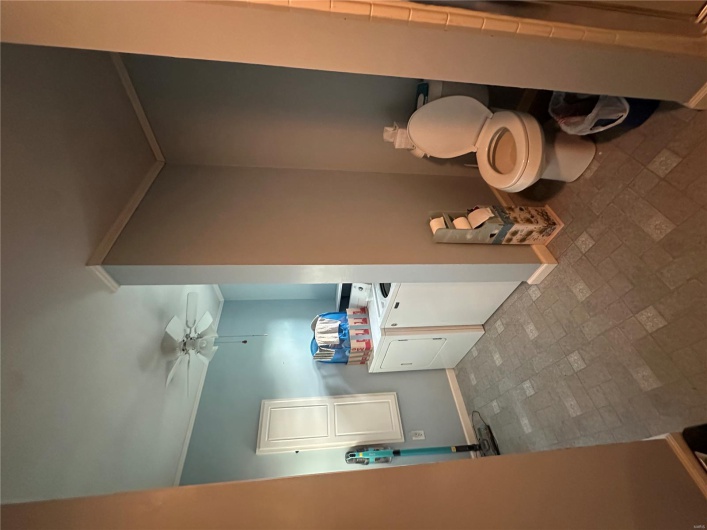 Bathroom featuring washer and clothes dryer, crown molding, brick patterned flooring, ceiling fan, and baseboards