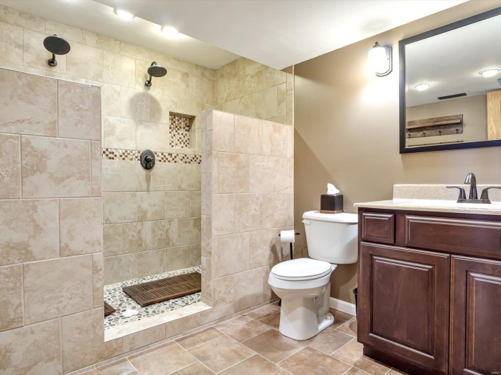 Full bath with a walk in shower, toilet, vanity, and baseboards