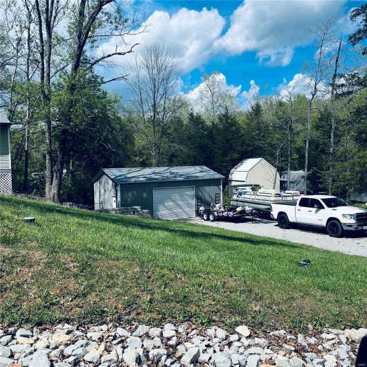 View of yard with an outdoor structure and a garage