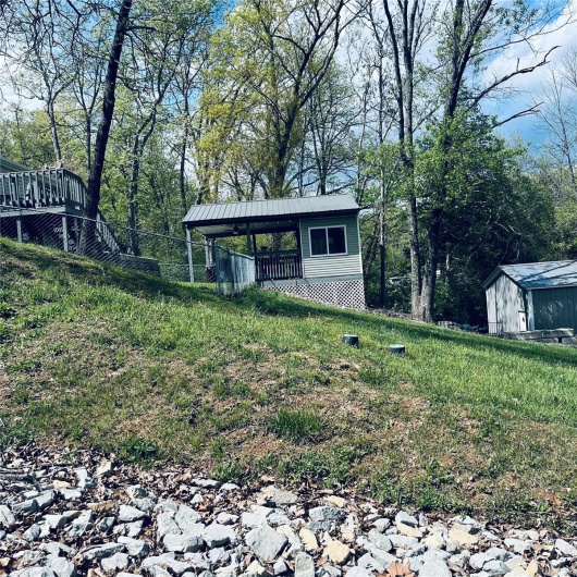 View of outbuilding featuring fence and an outbuilding
